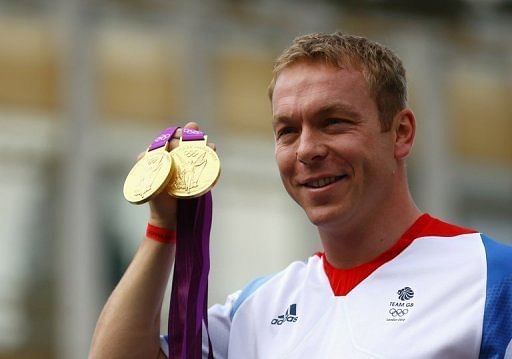 Chris Hoy poses with his gold medals in central London on September 10, 2012